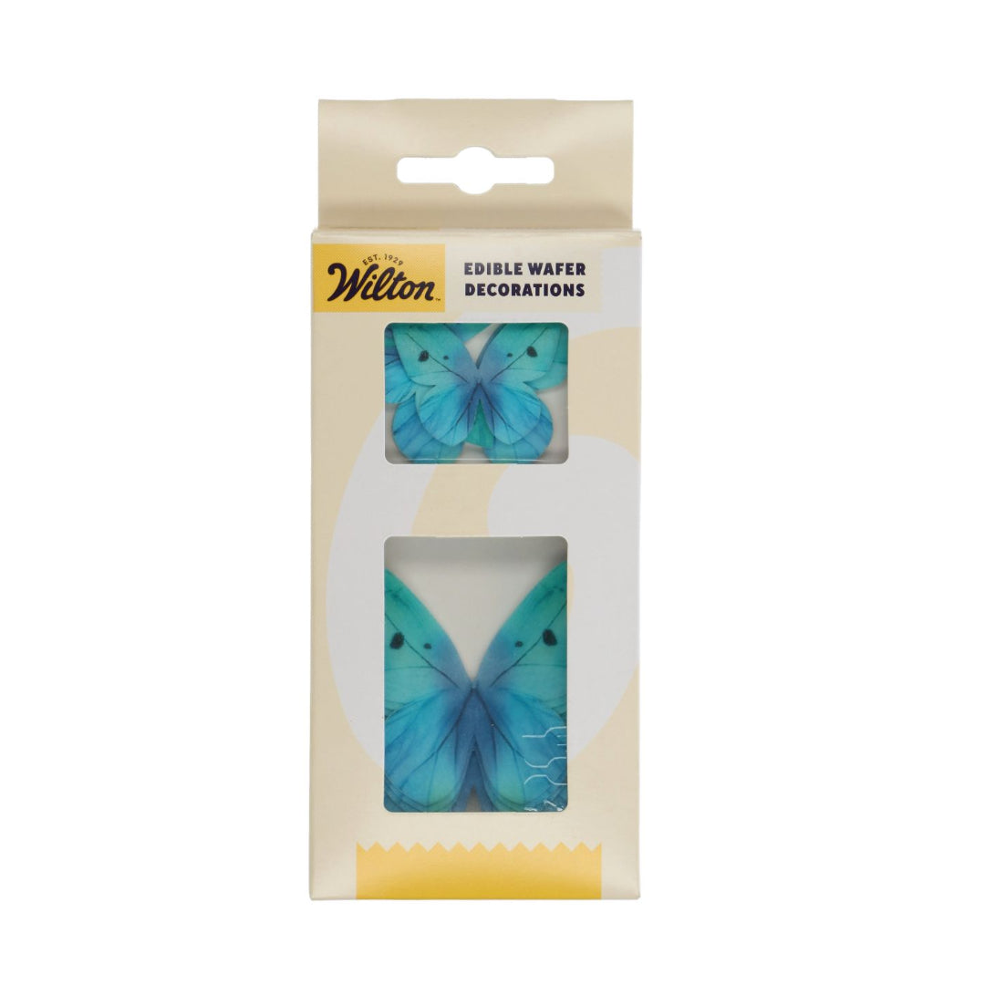 Packaged blue butterfly wafer decorations with Wilton branding on a white background