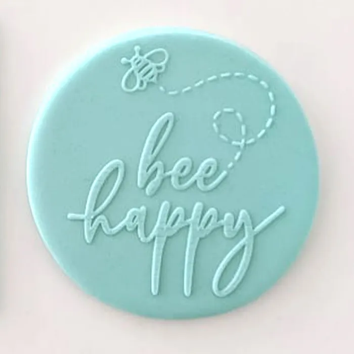 Example of embossed teal fondant icing with Bee Happy