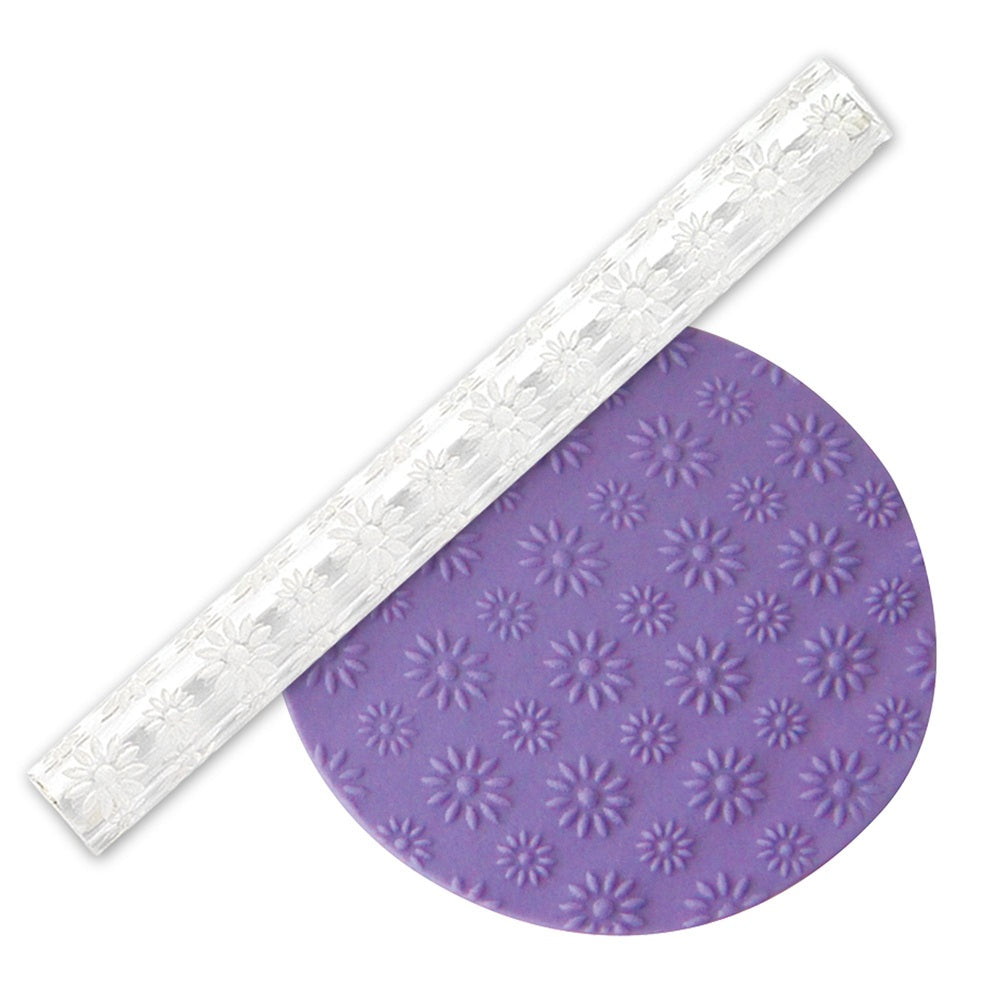 Daisy embossed acrylic rolling pin, along side a purple fondant examples embossed with the design