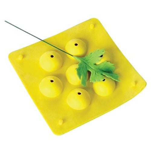 A bright yellow square flower former with six circular cavities, shown on a white background with a green gumpaste leaf and wire prop.