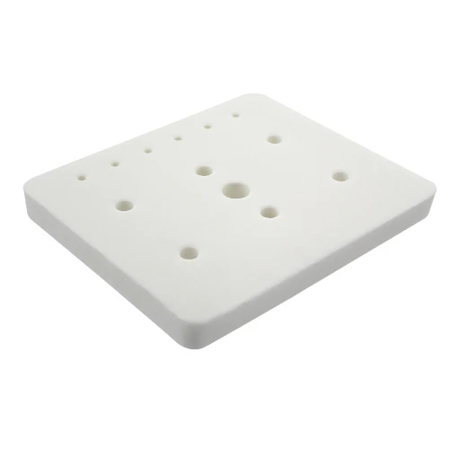 A square white foam pad with rounded corners and multiple circular holes, shown on a plain white background.