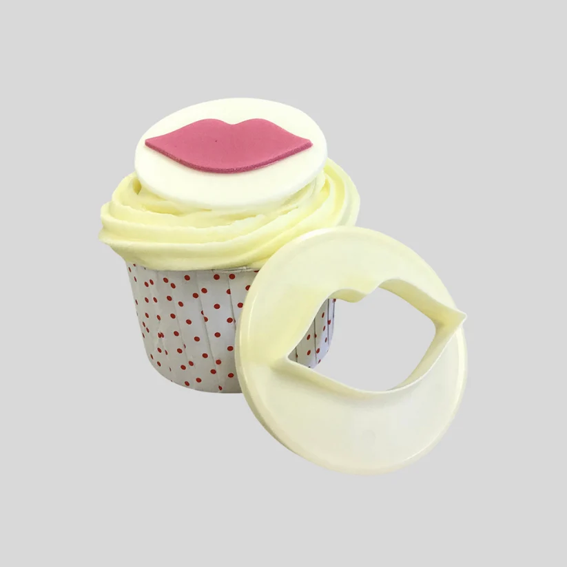 cupcake topped with a fondant plaque with red lips