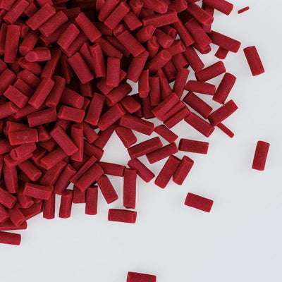 Red chocolate chips scattered on a white background