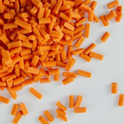 Orange chocolate chips on a white background