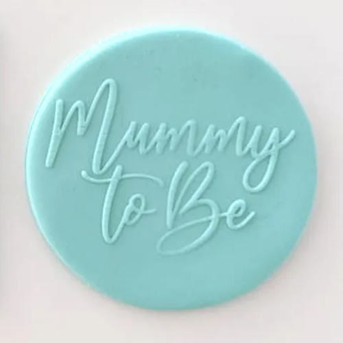 A round, light aqua fondant blue plaque featuring the embossed script text 'Mummy To Be' on a plain white background.