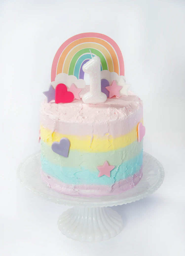 Colorful cake with rainbow, stars, and hearts on a white background