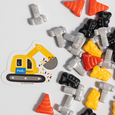 Construction-themed candy sprinkles with a die-cut sticker of an excavator on a white background