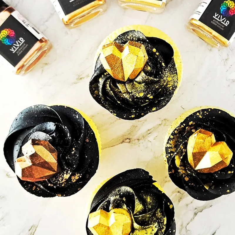 Rose Gold and Gold lustred geode hearts on cupcakes - example of how the Vivid edible metallic dusts can be made into a paint to create a splatter pattern across black buttercream icing prior to placing lustered decorations for a stunning effect.