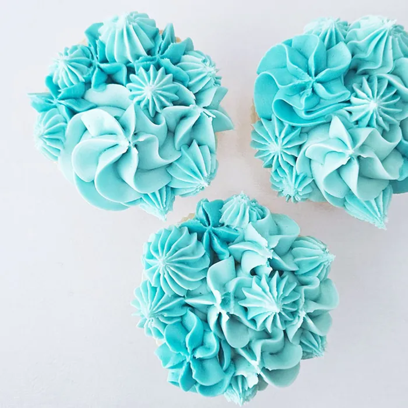 Examples of piped cupcakes created using the large nozzle piping tip set