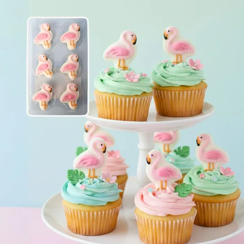 Flamingo edible cupcake toppers on cupcakes frosted with mint green buttercream.