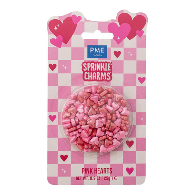 Packaged pink heart-shaped sprinkles with PME Cake Sprinkle Charms branding on a checkered background.