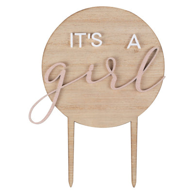 Wooden cake topper with 'It's a girl' text on a white background