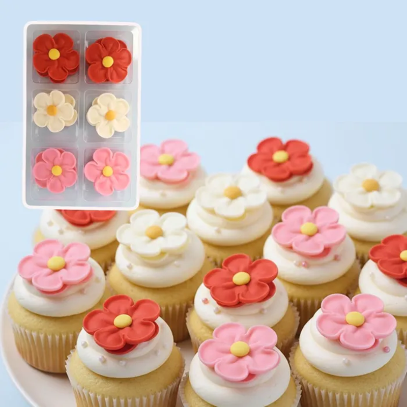 Decorative flower-shaped cupcake toppers on cupcakes with a close-up of the topper set.