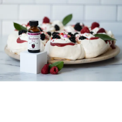 Raspberry lorann flavour bottle with decorated meringues inbackground