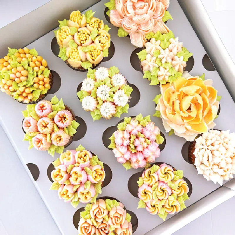 Examples of piped buttercream cupcakes, using Russian tips to create floral blooms