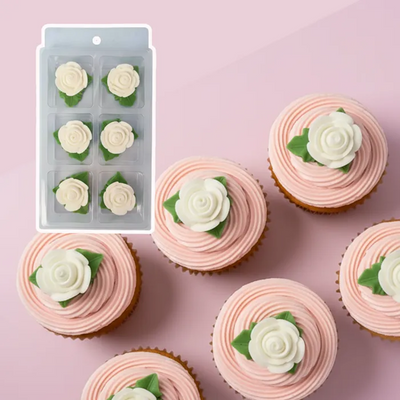 Cupcakes with pink frosting and white rose decorations on a pink background