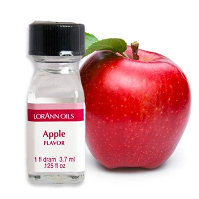 A small bottle labeled Lorann Oils with Apple flavor, next to a red apple with a leaf on it.