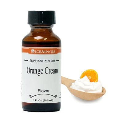 A bottle of Lorann's Orange Cream Super-Strength Flavouring, with a spoonful of orange cream next to it.