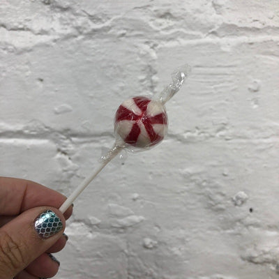 Red and white round ball swirly lollipop