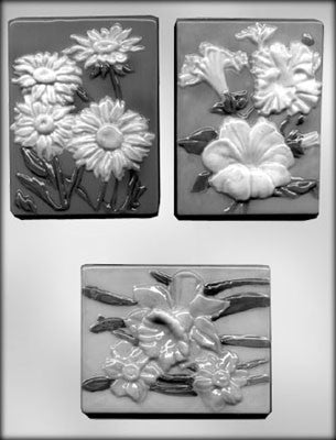 Three assorted flower plaques for chocolate moulds, depicting different flowers Daisy, petunia and daffodil.