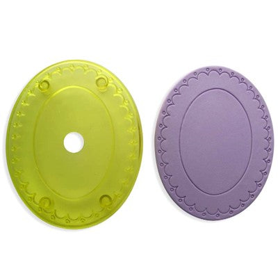 An oval-shaped cookie cutters, in green and an icing example in purple in purple, with a fluted edge design.