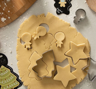 Selection of cookie cutters and biscuit dough