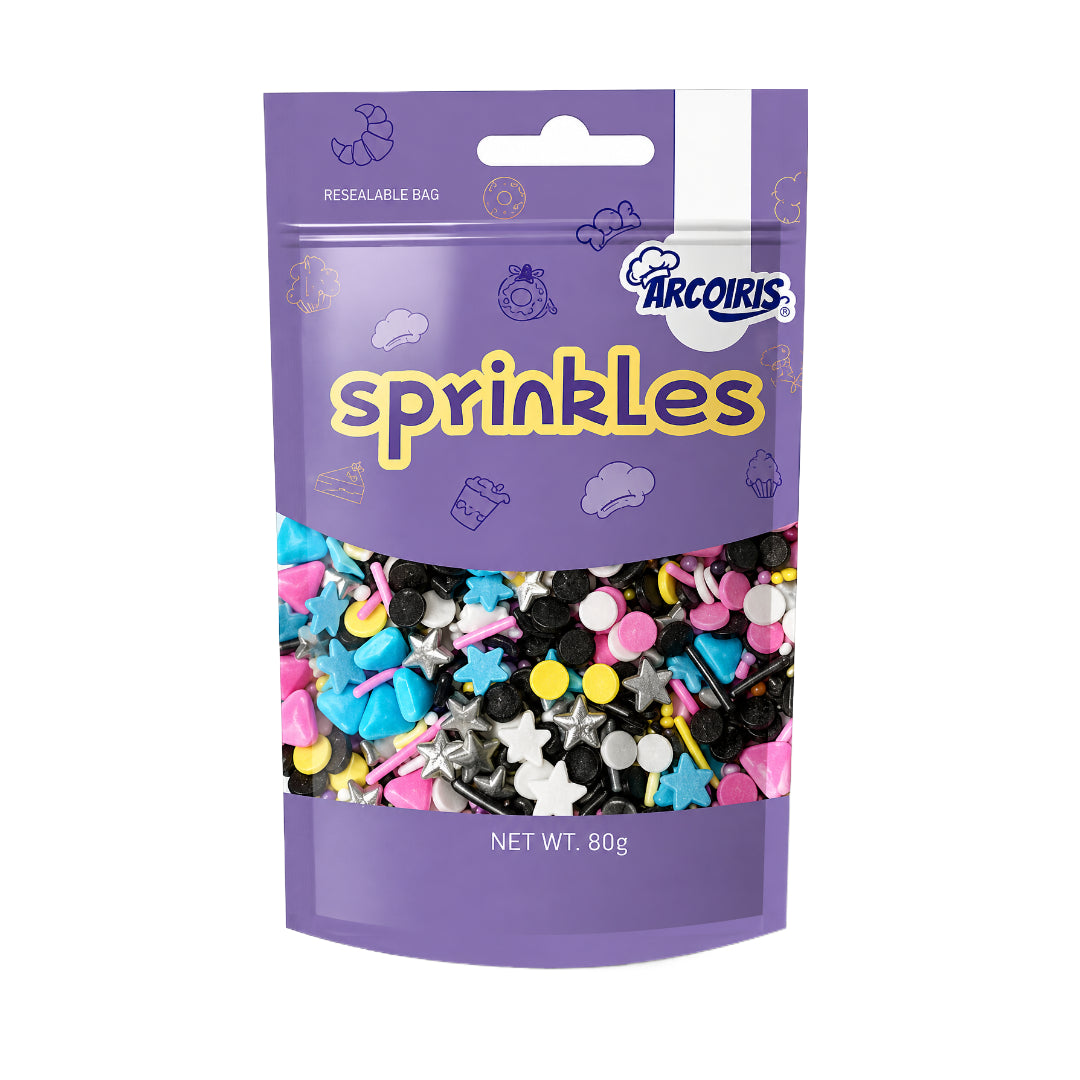Arcoiris retail packaging with Retro Sprinkle Mix. Of hot pink, electric blue, sunshine yellow, black, white and shimmering silver colours. Shapes are - stars, triangles, rods and confetti.