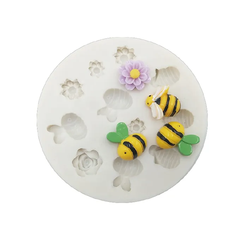 Silicone mold with bee and flower shapes on a white background