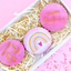 Pink cookies with 'Happy Birthday Girl' text in a decorative box on a pink background