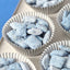 Puppy chow treats made by dipping in blue candy melts and powdered sugar