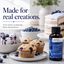 A bottle of LorAnn Blueberry Flavoring shown in a styled kitchen scene with blueberries, blueberry muffins, blueberry ice cream, and a blueberry cake. Text on the image reads 'Made for real creations.