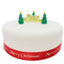 Christmas cake with a gold plaque and three christmas tree toppers