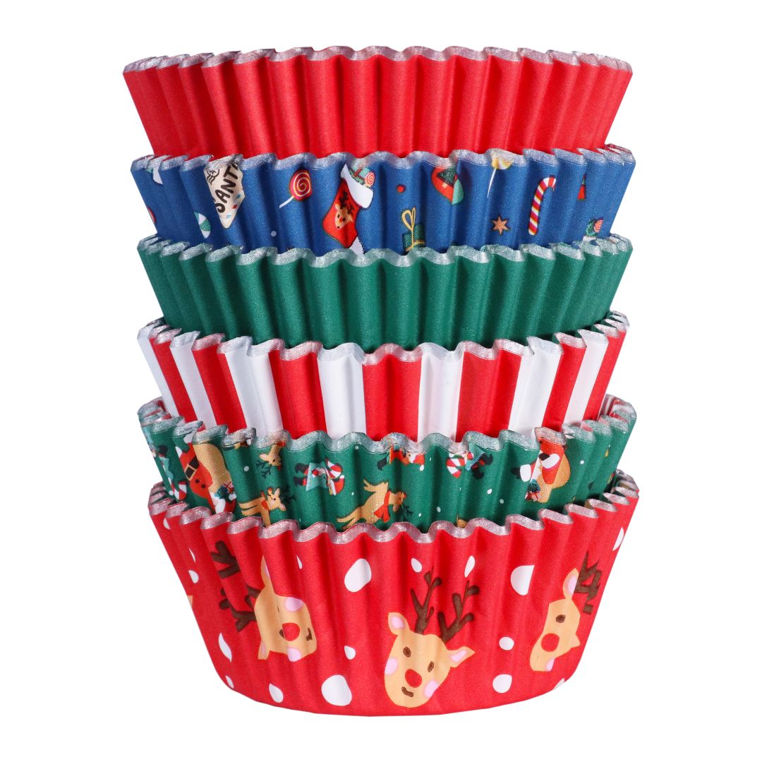 Stack of colorful PME cupcake liners with Christmas designs on a white background