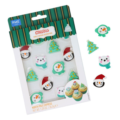 Packaged Christmas-themed cupcake decorations with penguins, trees, and other festive elements.