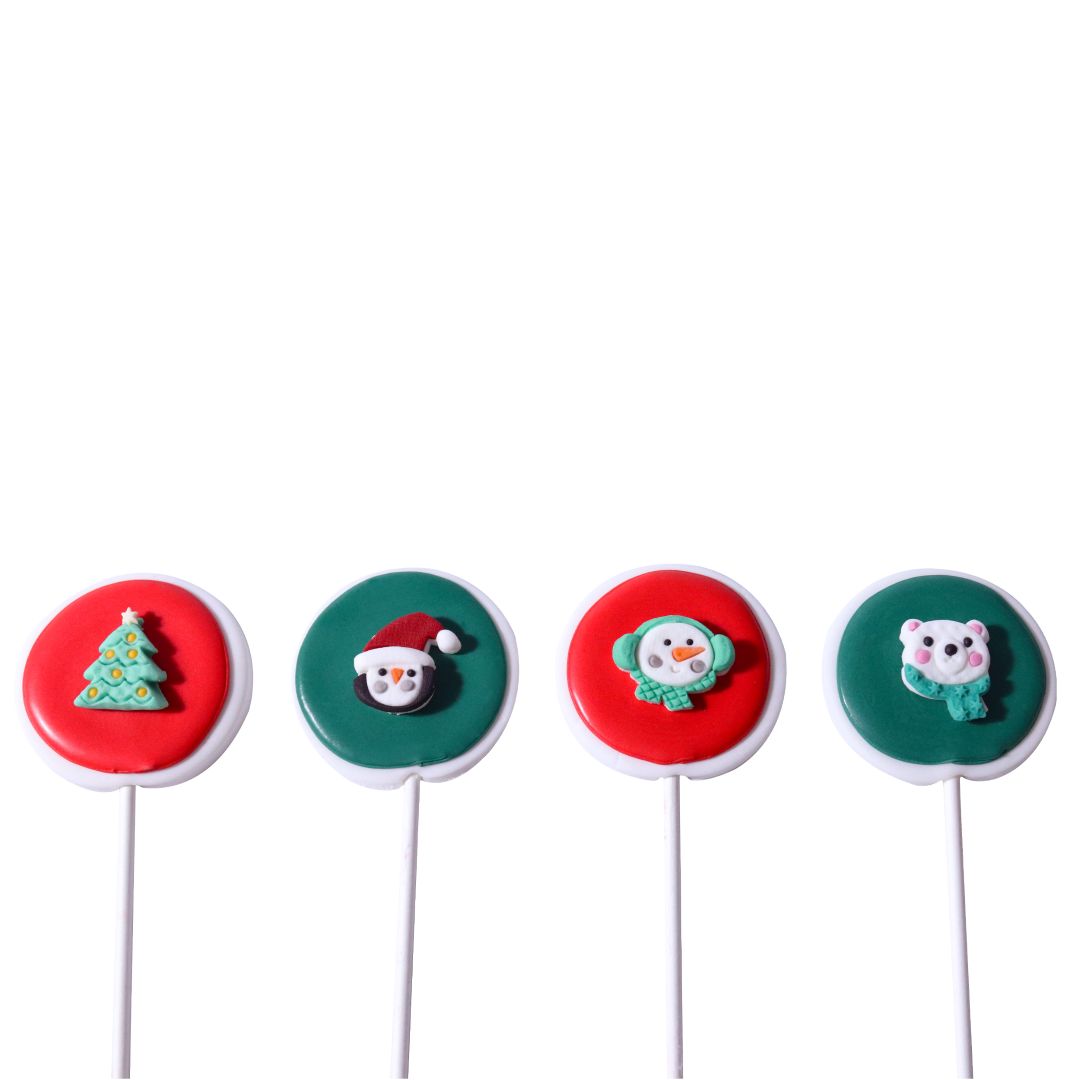Four Christmas-themed lollipops on sticks with colorful designs.