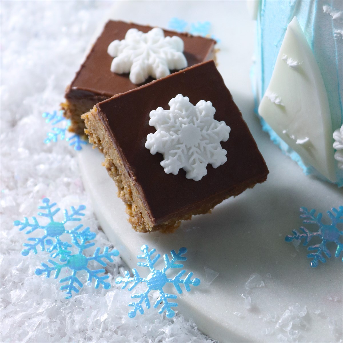 Chocolate bars with snowflake decorations on a snowy background