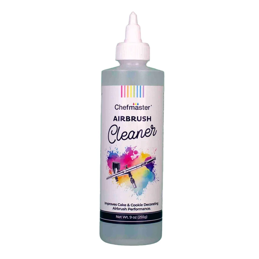 A 9 oz bottle of Chefmaster Airbrush Cleaner with a white cap and a white label featuring a colorful paint splatter graphic, set against a plain white background.