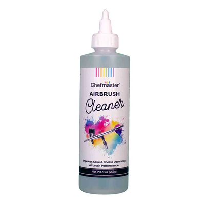 A 9 oz bottle of Chefmaster Airbrush Cleaner with a white cap and a white label featuring a colorful paint splatter graphic, set against a plain white background.