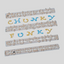 Set of fmm plastic cutters with fondant examples spelling 'CHUNKY FUNKY' on a light gray background
