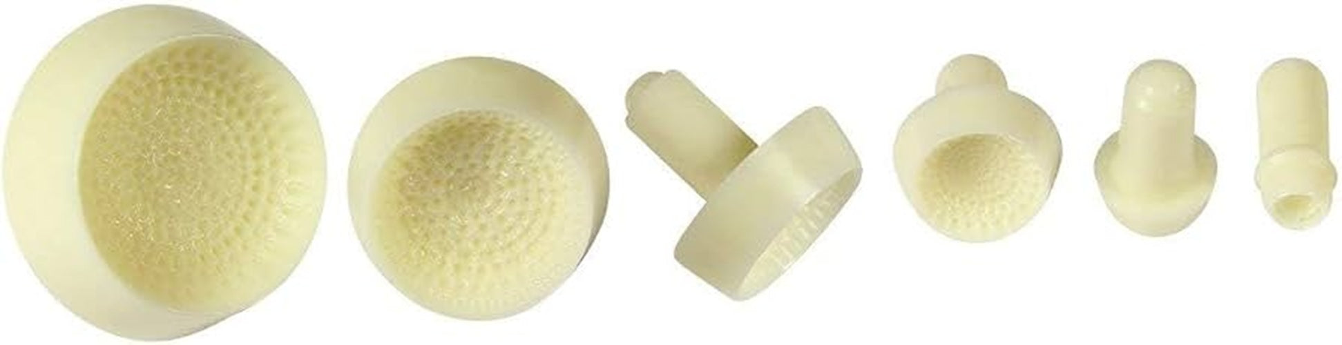 Six small off-white plastic cylindrical and round daisy cente stamps for icing with textured inner surfaces, arranged on a plain white background.