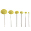 Six yellow textured pom-pom daisy centres for icing flowers of decreasing sizes on thin dark wire stems, arranged in a row against a plain white background.