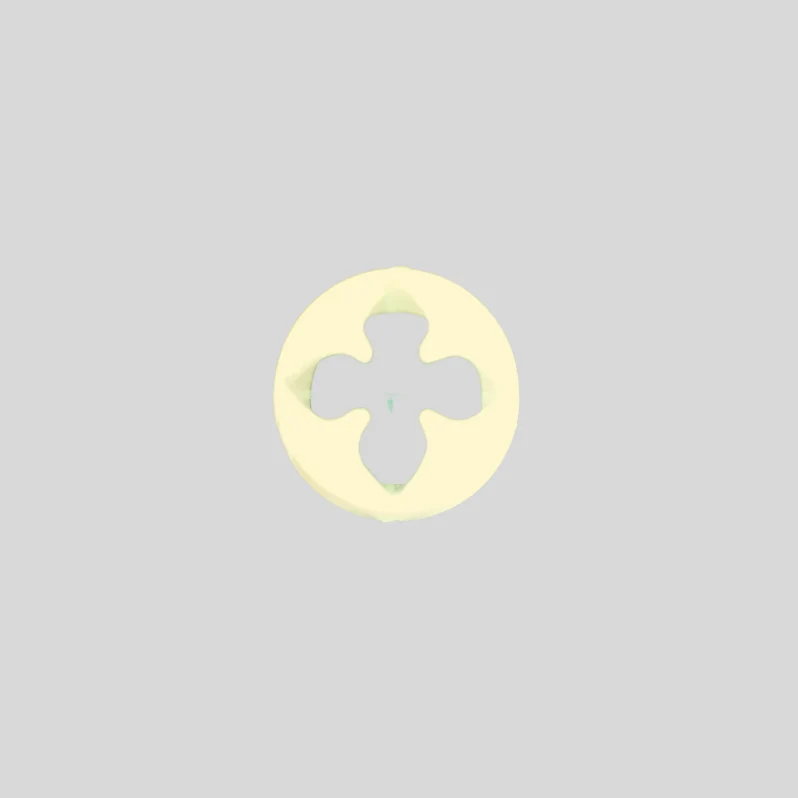 A pale yellow gumpaste flower cutter with a four-pointed star cutout in the center, shown on a solid light gray background.