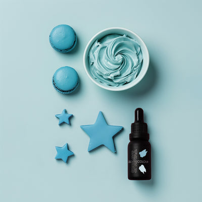 Blue-themed icing examples including a bowl of blue buttercream, macarons, star-shaped fondant cut outs, and a bottle on a light blue background.
