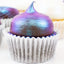 Cupcake with iridescent purple and blue frosting in a white paper cup.