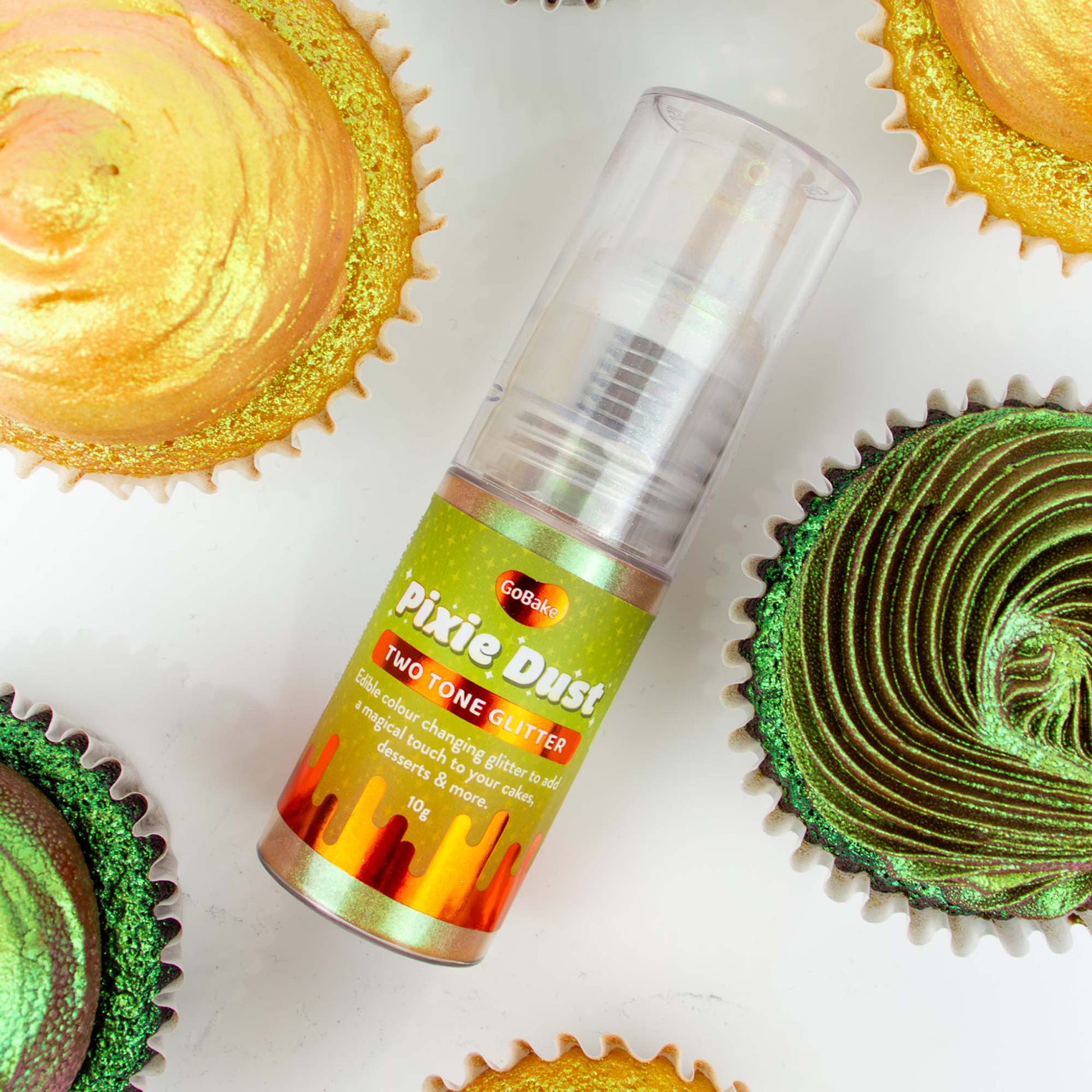 Can of 'Pixie Dust' two-tone glitter with cupcakes decorated with green and gold glitter on a white background