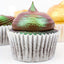 Cupcake with iridescent green and purple frosting on a white background