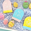 Easter themed cookie set in bright colours. Some read Happy EAster. Others are shaped like eggs.