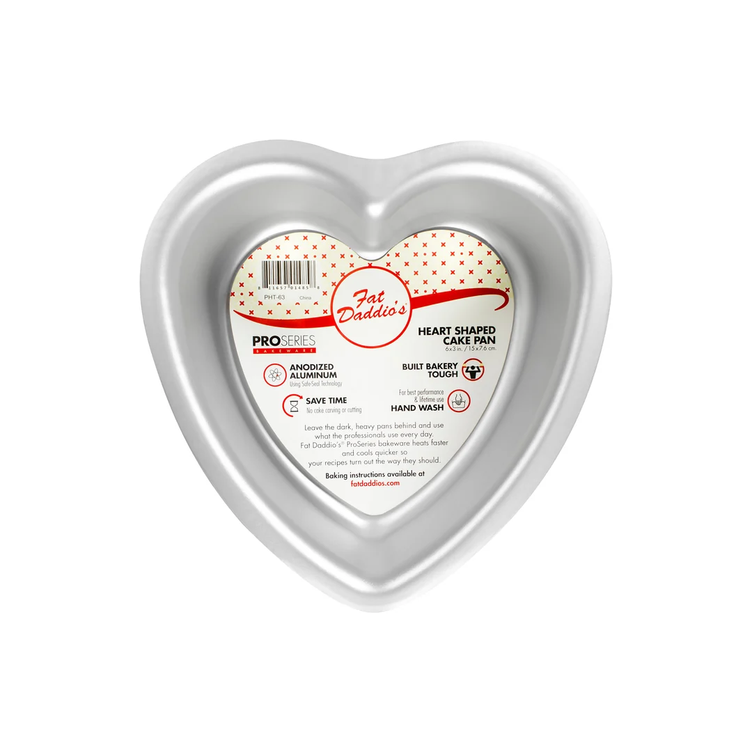 A heart-shaped aluminum cake pan by Fat Daddio's, featuring a silver metallic finish and a central paper label with product information.