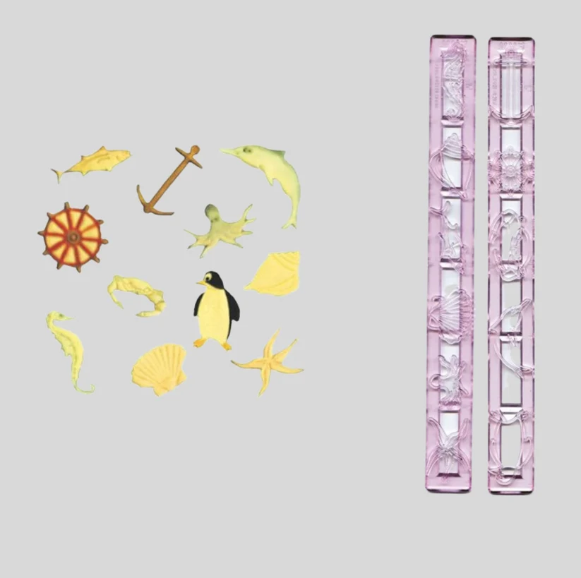 fmm marine cutter set, along with fondant examples from the set of a crab, anchor, seahorse, starfish, shell, octopus, helm wheel, clamshell, penguin, dolphin and shark