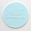 a blue fondant plaque embossed with "First Communion"